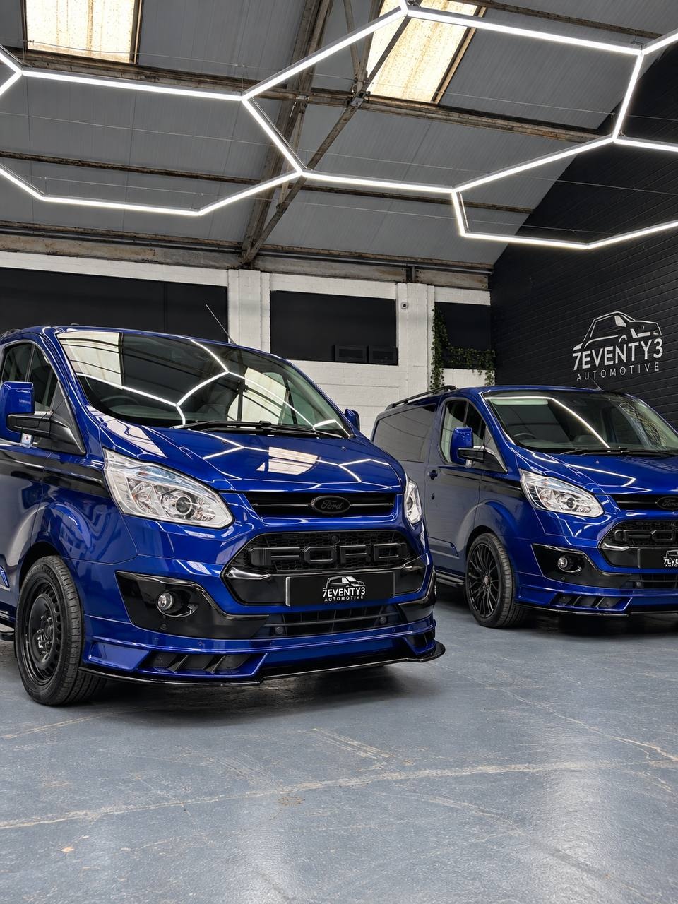 Two blue Seventy3 vans in the Annan showroom